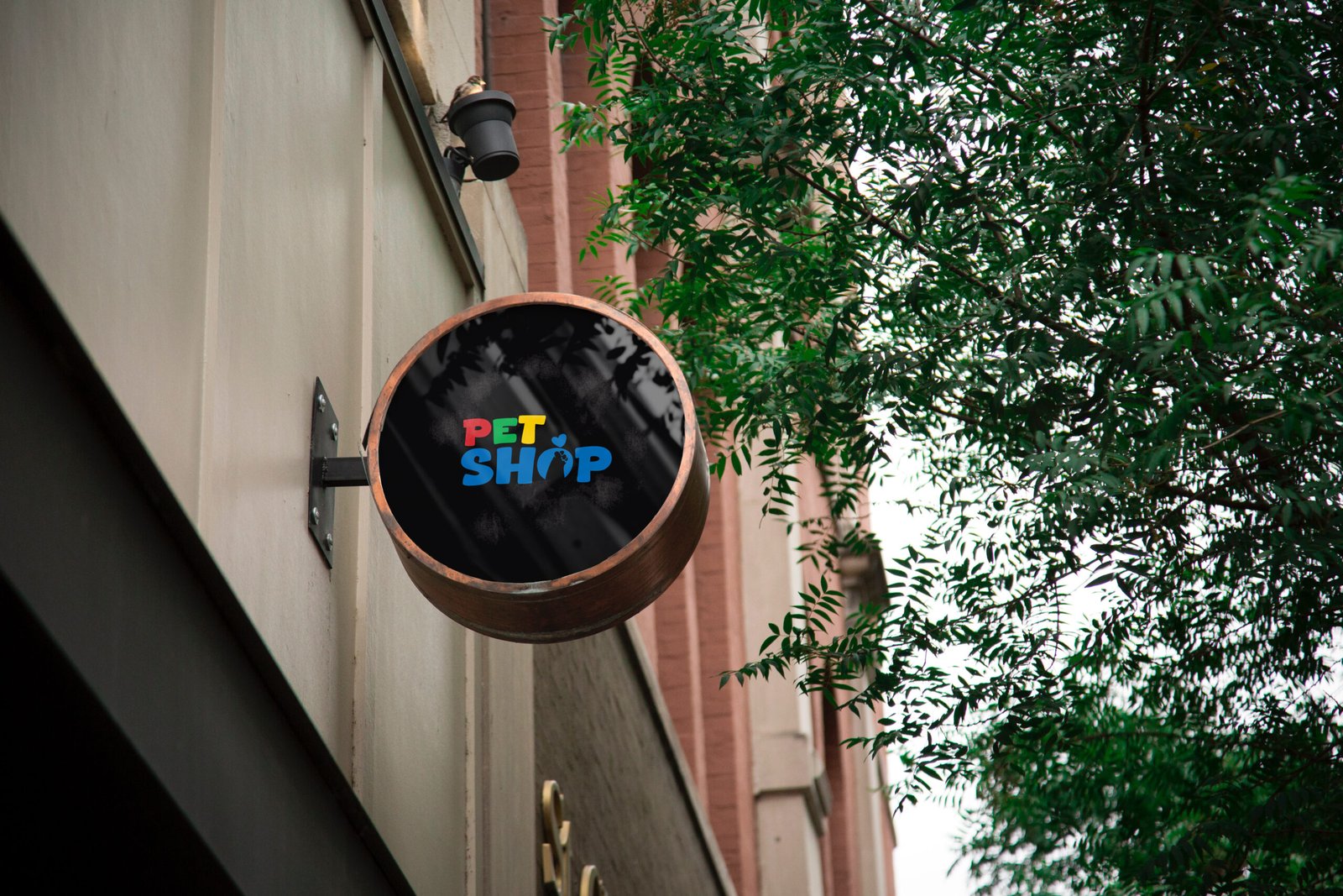 Pet Shop signboard design featuring a colorful pet store logo on a round outdoor storefront sign.